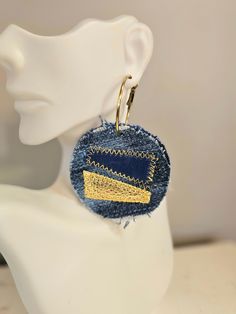 a close up of a pair of earrings on a mannequin head