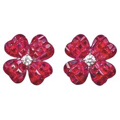 Four-leaf clover stud earrings, designed as an invisibly-set calibre-cut ruby clover centering a round brilliant-cut diamond. Handcrafted in polished 18k white gold. Rubies weighing 11.15 total carats. Two diamonds weighing 0.20 total carats. Posts with medium friction backs signed '750' for pierced ears. 0.6" diameter. Clean Gold Jewelry, Ruby Earrings Studs, Silicone Wedding Rings, White Gold Earrings Studs, White Gold Studs, Mens Gold Jewelry, Clover Earrings, Ruby Earrings, Diamond Flower