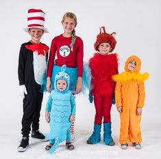 three children in costumes standing next to each other with one child wearing a cat in the hat costume