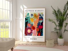 a flower market poster hangs on the wall next to a couch and potted plant