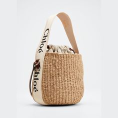 Chloe x Mifuko "Woody" bucket bag in straw, cotton, and leather  Branded flat web top handle  Flat shoulder strap Drawstring closure  Leather lining  Approx. 6.3"H x 6.7"W x 6.3"D Made in Italy Spring Bucket Crochet Bag With Handles, Top Handle Jute Bucket Bag, Cream Bucket Straw Bag With Adjustable Strap, Cream Woven Bucket Shoulder Bag, Woven Bucket Bag For Shopping, Spring Woven Bucket Bag With Double Handle, Straw Bucket Bag For Shopping, Straw Shopping Bucket Bag, Natural Bucket Bag With Bamboo Handle