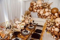 a table is set up with balloons and plates