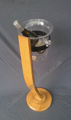 a wine glass holder with two bottles in it on a grey background is the only thing that can be seen here