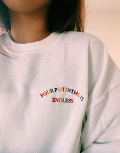 Our 'Your Potential Is Endless' embroidered unisex heavy-blend sweatshirt is made with air-jet spun yarn for a soft and comfy fit. heavy-blend Unisex fit. We are a small business and all our items are made as ordered, so items can take around 3-8 business days to ship out our embroidered sweatshirts - but we will try our best to make sure our packages get to their new homes as soon as possible! Thank you for understanding. Please reference our sizing chart pictured in the photos in order to get White Sweatshirt With Custom Embroidery In Relaxed Fit, White Sweatshirt With Custom Embroidery, Relaxed Fit, Multicolor Embroidered Logo Sweatshirt Crew Neck, Embroidered Logo Crew Neck Sweatshirt, Multicolor Embroidered Text Crew Neck Sweatshirt, Cotton Crew Neck Sweatshirt With Embroidered Patch, Casual Multicolor Embroidered Letter Sweatshirt, White Crew Neck Top With Embroidered Patch, Crew Neck Sweatshirt With Multicolor Embroidery