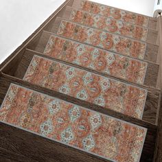 a set of three rugs sitting on top of a wooden floor next to an open door