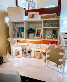 a white desk topped with a mirror and lots of shelves filled with books on top of it