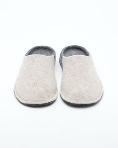 Description: The Nuvola Bico in beige and grey is our soft clog slipper, fully crafted in wool with a 1.5 cm interior heel height EVA insole for added comfort. The Nuvola retains the look of a slipper with the cushioned feel of a sneaker. Designed for the perfect amount of support and feather lightweight, Nuvola feels almost like walking on a cloud. Details: 100% Wool felt upper Two tone design: Colored front with light grey rear and insole Removable 1.5 cm interior heel height EVA insole - for Cream Slippers With Cushioned Footbed And Round Toe, Beige Round Toe Slippers With Removable Insole, Winter Beige Closed Toe Clogs, Beige Comfortable Clogs With Cushioned Footbed, Comfortable Beige Clogs With Cushioned Footbed, Casual Wool Slippers With Leather Sole, Comfortable Beige Clogs With Textured Footbed, Comfortable Slippers With Rubber Sole And Flat Heel, Beige Slippers With Leather Sole And Flat Heel