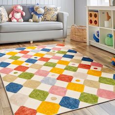 a child's play room with colorful rugs and teddy bears on the floor