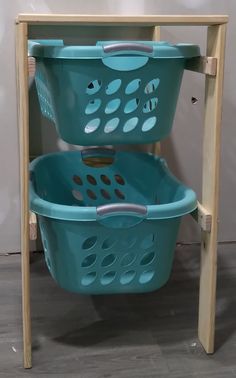 two blue baskets sitting on top of a wooden shelf