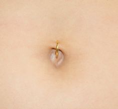 a close up of a woman's stomach with a ring on it