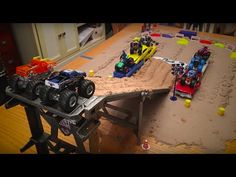 some toy cars are on a table in the middle of a play area with sand