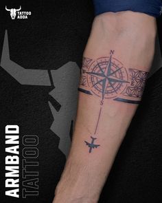 a man with a compass tattoo on his arm