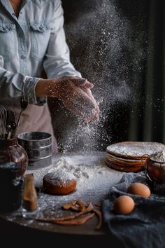 a person is sprinkling flour on some food