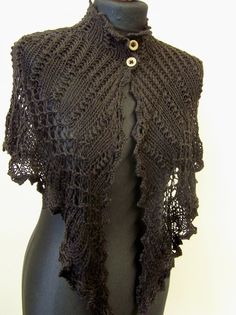 a mannequin wearing a black shawl with buttons