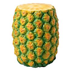 a yellow and green pineapple planter sitting on top of a white surface