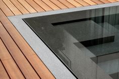 a close up of a glass window on a wooden floor with wood slats in the background