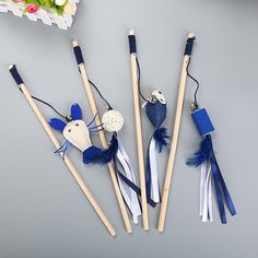 four toothbrushes with blue and white decorations on them