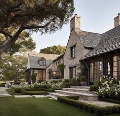 a large house with lots of windows and landscaping