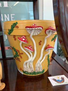 there is a pot that has mushrooms painted on it