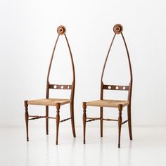 two wooden chairs sitting next to each other