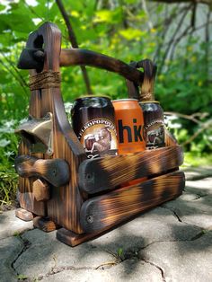 a wooden tool holder with beer cans in it