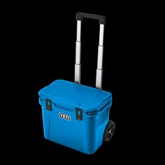 a blue rolling cooler with wheels and handles