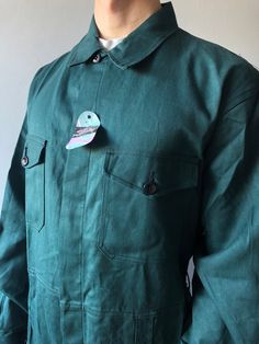 Workwear Pants / Work Coveralls / French Chore Pants / French Workwear / Size M-L This vintage coveralls in good unuse condition! - made in Belgium - color - green - 4 front pockets  - 2 cuff buttons - 7 buttons at front - material - sanforized cotton - fit size M/L (watch measurements) FLAT Measurements: Shoulders : 53cm Chest (underarm to underarm) : 60cm Sleeve : 67cm Length(back) : 92cm Waist : 47cm + elasticated waistband Inseam : 78cm Hem trousers : 25cm Model height and weight reference ( Vintage Coveralls, Work Coveralls, French Workwear, Mens Overalls, Workwear Pants, Military Outfit, 31 Days, Vintage Military, Work Pants