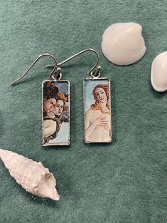 Add more beautiful art to your daily life with these fine art earrings. They feature a close up look at Botticelli's birth of Venus. The earrings are sure to get compliments from those who seek out unique jewelry as well as from art and mythology lovers. Nickel Free Rectangular Pendant Earrings As Gift, Nickel-free Rectangular Pendant Earrings As Gift, Handmade Artistic Rectangular Earrings, Artistic Handmade Rectangular Earrings, Artsy Sterling Silver Earrings As A Gift, Artsy Sterling Silver Earrings For Gift, Artsy Sterling Silver Earrings Gift, Handmade Rectangular Pendant Earrings As A Gift, Handmade Rectangular Pendant Earrings For Gift