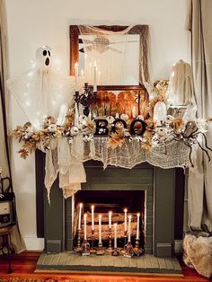 a fireplace decorated with halloween decorations and candles