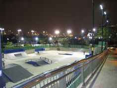 an empty skate park at night with lights on