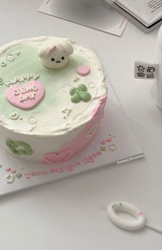 there is a cake on the table that has been decorated with pink and green decorations