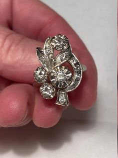 "Antique Art Deco Retro 14K white gold and mine cut diamond floral ring signed Kinsley & Sons, GOTHIC. The ring is a size 7.5 and weighs 6 grams. The face is 15/16\" tall x 5/8\" wide. Four 3mm round mine cut diamonds and seven 2mm round mine cut diamonds in open back illusion prong settings. Approximate .65 TCW. Lots of sparkle. Marked 14K, Gothic. Excellent condition. Beautiful high art deco design, wonderful ring." Art Deco Gia Certified Collectible Rings, Black Art Deco Jewelry With Rose Cut Diamonds, Collectible Art Deco Gia Certified Rings, Luxury Enamel Art Deco Rings, Platinum Multi-stone Art Deco Rings, Heart Piercing, Dagger Earrings, Gold Mine, Deco Retro