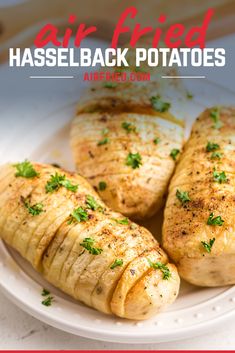 four baked potatoes on a white plate with the words air fried hasselback potatoes