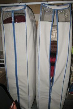 two large white bags sitting next to each other in front of a closet filled with clothes