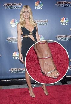 a woman standing on top of a red carpet with her foot in the middle of it