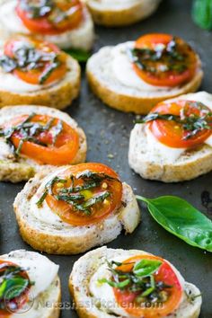 small appetizers with tomatoes and cream cheese on them are ready to be eaten