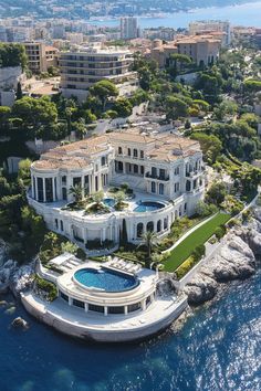 an aerial view of a mansion on the water