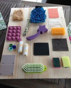 the table is covered with different types of crafting supplies on it, including sponges and mop heads