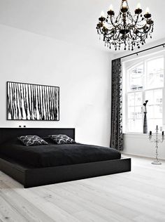 a black and white bedroom with a chandelier