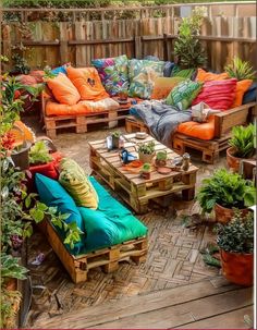 an outdoor seating area with couches, tables and potted plants