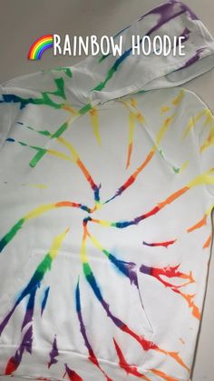 the rainbow hoodie is made with white and multicolored tie - dyed fabric