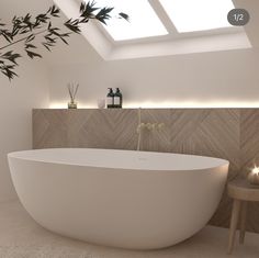 a white bath tub sitting under a skylight