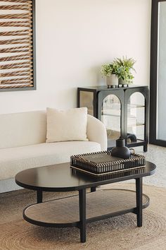 a living room with a white couch and coffee table