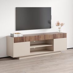 an entertainment center with a flat screen tv mounted on the wall