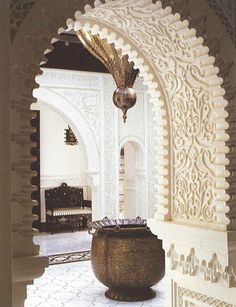 an ornate archway with a vase in the middle