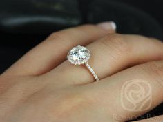 a woman's hand with a diamond ring on it