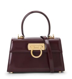 Made in Italy

Highlights:
chocolate brown
calf leather
Gancini plaque
gold-tone hardware
single top handle
metal feet
foldover top with press-stud fastening Versace Outfit, Chanel 2, Iconic Bags, Flat Boots, Ballet Flat Shoes, Accessories Branding, Leather Tote Bag, Chocolate Brown, Leather Tote