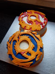 two decorated cakes sitting on top of a table