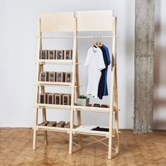 a clothes rack with books and t - shirts on it