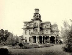 an old photo of a large house in the day time